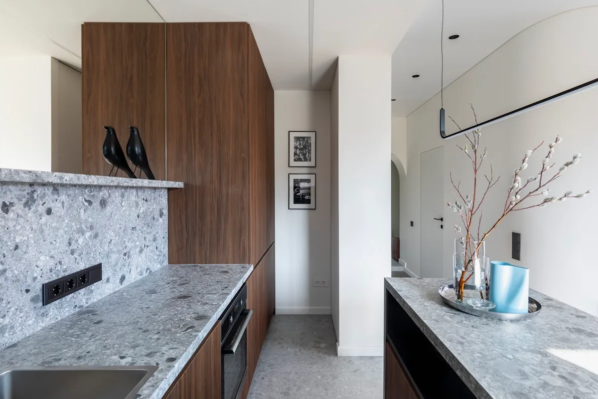 Flat-panel walnut cabinetry with a slab-front finish, matching an Eichler post-and-beam kitchen