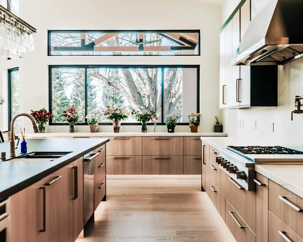 Renovated Eichler kitchen with clerestory windows, walnut cabinetry, and a garden view