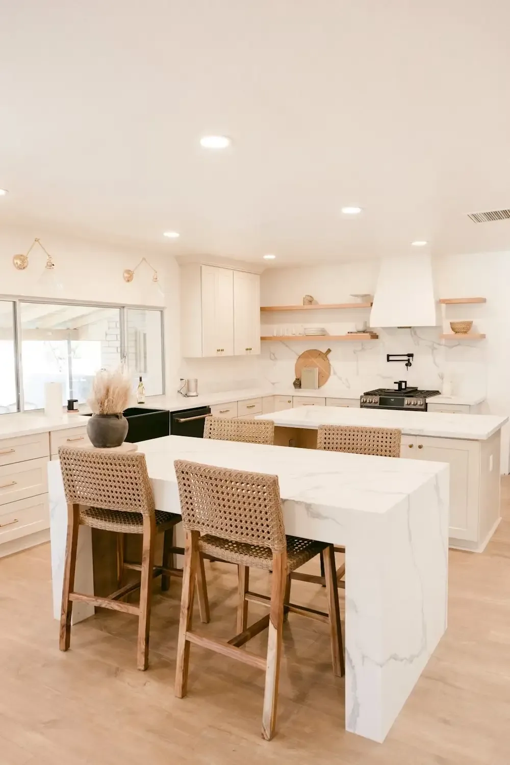 Renovated Palo Alto kitchen with white oak island, waterfall quartz countertop, and woven counter stools